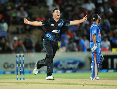 New Zealand's Mitchell McClenaghan celebrates the wicket of India's Ajinkya Rahane for 36 during their second one-day international cricket match, at Seddon Park, in Hamilton, New Zealand, Wednesday, Jan. 22, 2014. (AP Photo/SNPA, Ross Setford) NEW ZEALAND OUT