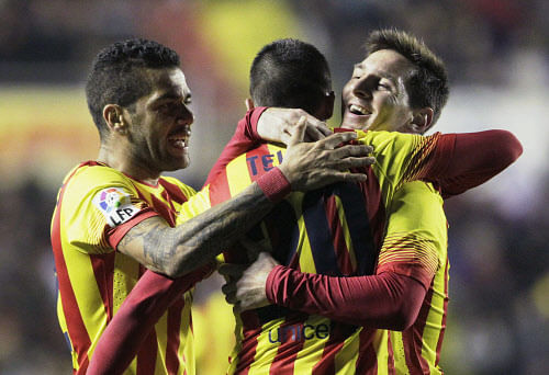 Barcelona's Cristian Tello (C) celebrates with teammates Lionel Messi (R) and Dani Alves after he scored against Levante during their Spanish King's Cup quarter-final first leg soccer match at the Ciudad de Valencia stadium in Valencia, January 22, 2014. REUTERS