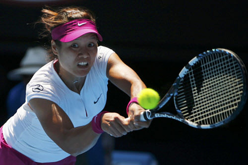 Li Na of China hits a return to Eugenie Bouchard of Canada during their women's singles semi-final match at the Australian Open 2014 tennis tournament in Melbourne January 23, 2014. REUTERS
