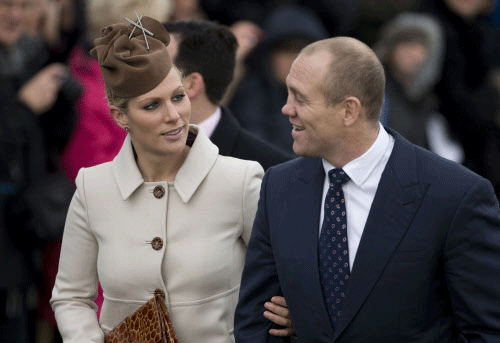 FILE - This is a Tuesday, Dec. 25, 2012 file photo of Britain's Queen Elizabeth II's granddaughter Zara Phillips and her husband rugby player Mike Tindall as they arrive for the British royal family's traditional Christmas Day church service in Sandringham, England. Queen Elizabeth II's new great-granddaughter has been named Mia Grace Tindall. The infant is the daughter of Zara Phillips and rugby player Mike Tindall. He tweeted her name Thursday, Jan. 23, 2104. AP photo