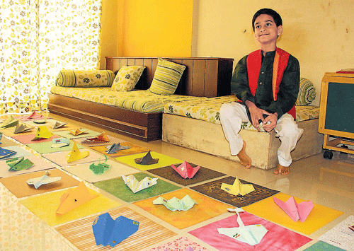 flying high: Eight-year-old Arnav Pawar with his paper replicas of different models  of planes. dh photo