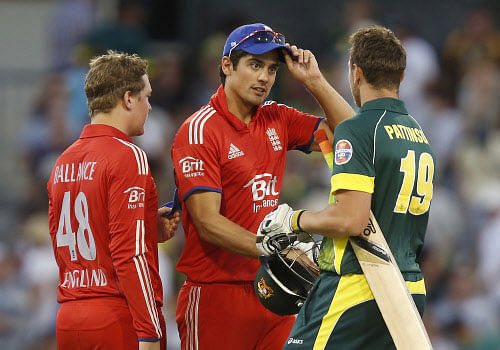 England's Alastair Cook, center, is congratulated by Australia's James Pattinson, right, on completion of their one day international cricket match in Perth, Australia, Friday, Jan. 24, 2014. England defeated Australia by 57 runs. AP Photo