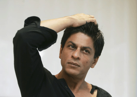 FILE - In this Dec. 8, 2008 file photograph, Bollywood actor Shah Rukh Khan gestures during an interview with The Associated Press at his residence in Mumbai, India. Khan's office said the Bollywood superstar has suffered a minor injury while shooting a new movie. He was shooting for director Farah Khan's new film at a luxury hotel in Mumbai when a door fell on him. AP photo