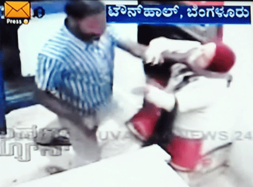 A screen grab of CCTV footage of an unidentified assailant attacks a lady inside an ATM in Bangalore last year as he tries to rob her of money.