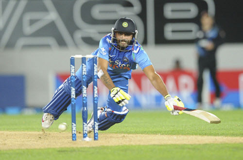 Ravindra Jadeja dives to make his ground against New Zealand during the third one day International cricket match at Eden Park in Auckland, New Zealand, Saturday, Jan. 25, 2014. AP Photo