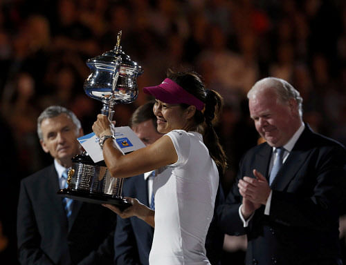 Li Na (front) of China poses with the Daphne Akhurst Memorial Cup after defeating Dominika Cibulkova of Slovakia in their women's singles final match at the Australian Open 2014 tennis tournament in Melbourne January 25, 2014. REUTERS