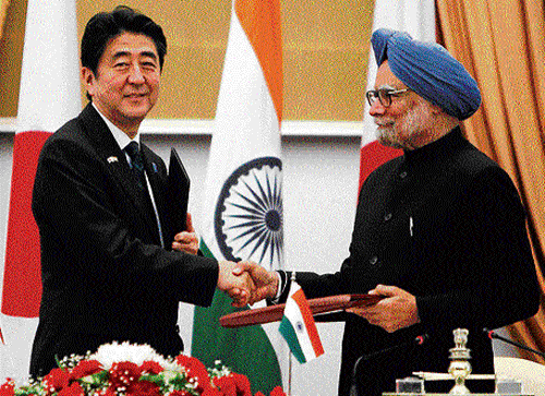 Japan's Prime Minister Shinzo Abe exchanges documents with his Indian counterpart Manmohan Singh after signing an MoU at the Hyderabad House in New Delhi on Saturday. PTI