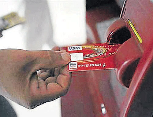 Even as its application to start a commercial bank is pending, India Post has drawn a massive plan to install as many as 3,000 ATMs and 1.35 lakh micro-ATMs at the ubiquitous post offices across the country for savings account holders by September 2015, a top official has said. DH File Photo. For Representation Only.