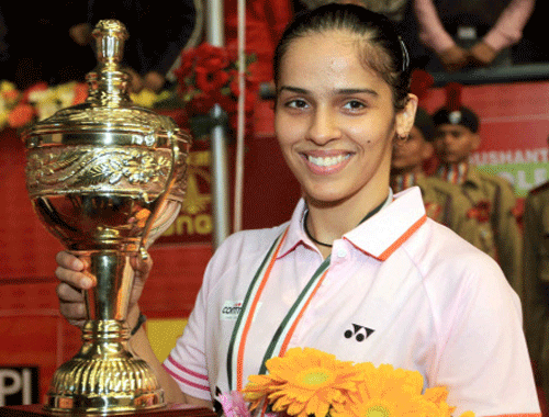 Saina Nehwal with winning trophy in the women title of Syed Modi Inaternational India Grand Prix Gold Badminton Championship at BBD Badminton Academy in Lucknow on Sunday. PTI Photo