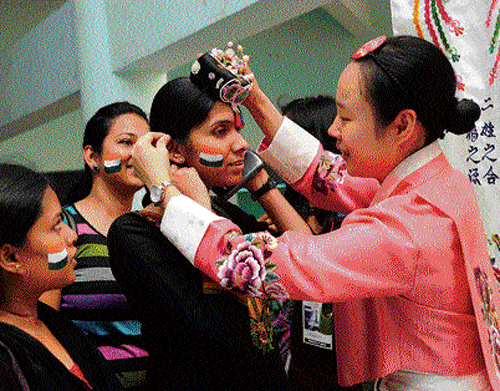 An exhibitor from South Korea shows bridal ornaments at the International Language Fair organised by Bangalore  University's Department of Foreign Languages on Sunday.  DH Photo