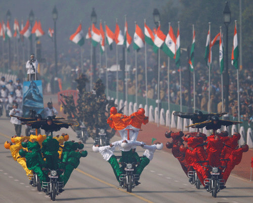 Army soldiers perform stunts on motorcycles during the Republic Day parade in New Delhi, India, Sunday, Jan. 26, 2014. Millions watched a display of the country's military power and cultural diversity amid tight security during national day celebrations. India adopted its democratic Constitution on Jan. 26, 1950. (AP Photo)