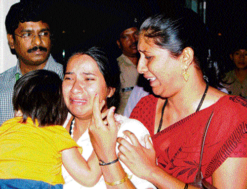 Survivors Gangabai and her daughter Dharshini break down in Chennai after hearing the news of her husband Suresh Shah's body being recovered, on Monday. PTI