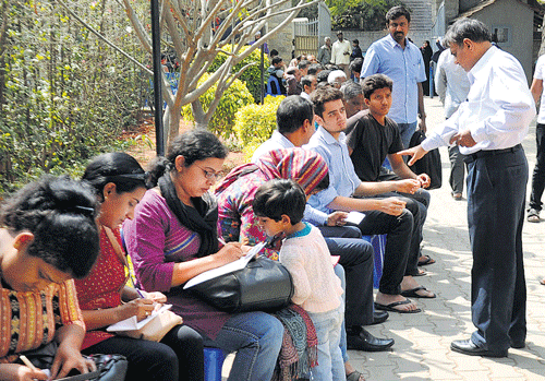 anxious Parents filling up forms for admission at St Francis Xavier School. DH photo by Kishor Kumar Bolar