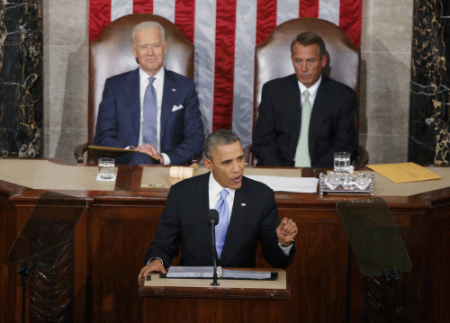With U.S. Vice President Joe Biden (L) and House Speaker John Boehner (R-OH) looking on, President Barack Obama (C) delivers his State of the Union address in front of the U.S. Congress, on Capitol Hill in Washington, January 28, 2014. REUTERS