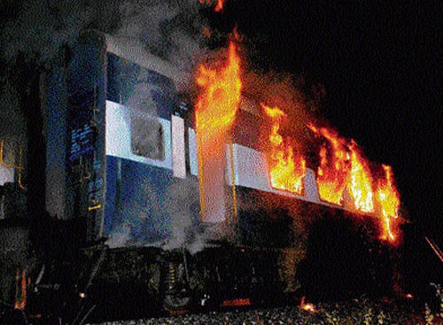 A file photo of the burning Bangalore-Nanded Express.