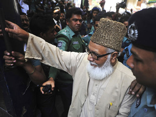 Matiur Rahman Nizami, head of the country's main Islamist opposition party Jamaat-e-Islami, enters a prison van at a court in Chittagong, Bangladesh, Thursday, Jan. 30, 2014. Nizami was among 14 people sentenced to death on Thursday on charges of smuggling weapons to a rebel group in neighboring India. AP Photo