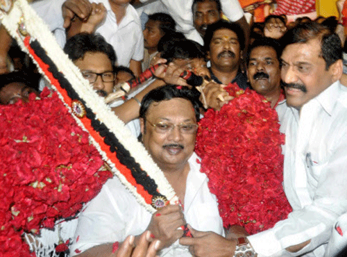 Former Union Minister and DMK Chief Karunanidhi's son M K Alagiri garlanded by D Napoleon and other supporters during his birthday celebration in Madurai on Thursday. PTI Photo