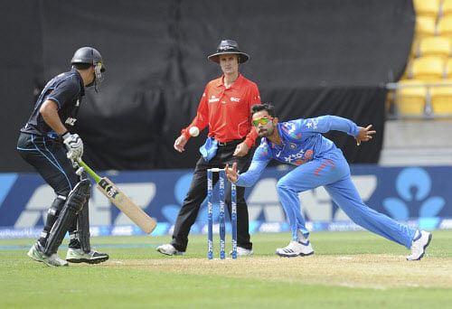 Virat Kohli, right, fields off his own bowling in front of New Zealand's Ross Taylor in the fifth and final one-day international cricket match in Wellington, New Zealand, Friday, Jan. 31, 2014. AP Photo