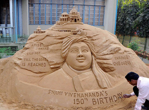Sand artist Subul Maharana makes a sand sculpture ahead of the 150th birth anniversary celebration of Swami Vivekananda, in Bhubaneswar on Friday. PTI Photo