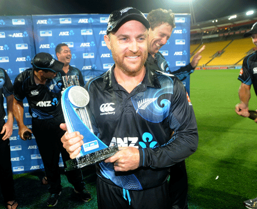 New Zealand's captain Brendon McCullum holds the trophy as his teammates celebrate after their series' victory over India during the fifth one day International cricket match at Westpac Stadium in Wellington, New Zealand, Friday, Jan. 31, 2014.  AP