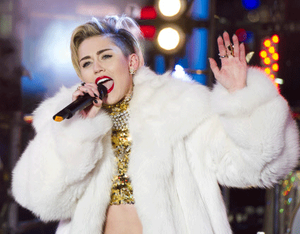 In this Dec. 31, 2013 file photo, Miley Cyrus performs in Times Square during New Year's Eve celebrations in New York. Cyrus is kicking off her North American "Bangerz" tour Feb. 14, 2014, in Vancouver. "Ren and Stimpy" creator John Kricfalusi and LA contemporary artist Ben Jones have crafted videos to play during the 38 shows as Cyrus prioritizes singing over dance routines. AP photo
