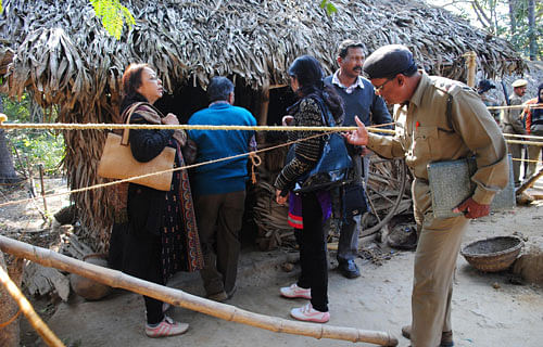 Policemen and forensic experts inspect the site where a woman was gang raped. AP File Photo