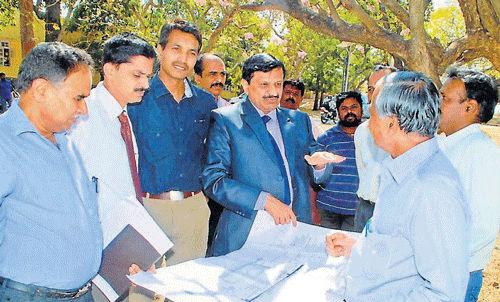 Director of&#8200;Sri Jayadeva&#8200;Cardiovascular Sciences and&#8200;Research Centre, Dr C&#8200;N&#8200;Manjunath inspects the plan for the new super speciality hospital, at PKTB&#8200;Sanitorium, in Mysore, on Saturday.