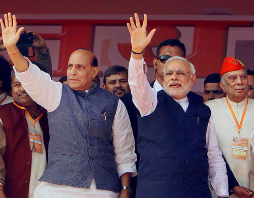 BJP prime ministerial candidate Narendra Modi with party president Rajnath Singh at the Vijay Shankhnaad rally in Meerut on Sunday. PTI