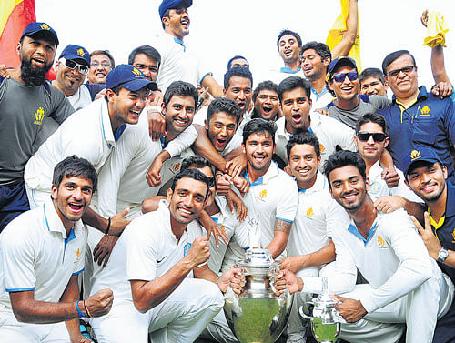 Karnataka players celebrate after winning the Ranji Trophy at the Rajiv Gandhi Stadium in Hyderabad. DH PHOTO/ SATISH BADIGER