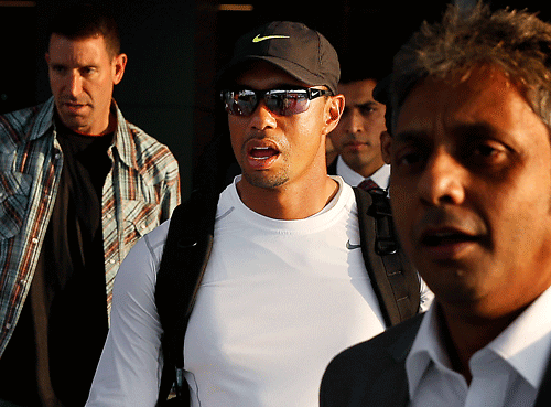 Tiger Woods, center, arrives at the Indira Gandhi International airport, in New Delhi, India, Monday, Feb. 3, 2014. Woods arrived Monday on his first visit to India to play an exhibition with a top business executive. (AP Photo)