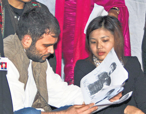 empathetic endeavour: Congress vice-president Rahul Gandhi looks at a sketch of Nido Taniam with north-east students who were staging a dharna at Jantar Mantar in New Delhi on Monday. Pti
