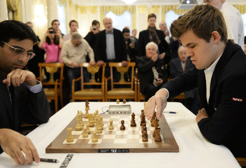 Norway's chess grandmaster Magnus Carlsen, right, reigning World Chess Champion and No. 1 ranked player in the world, plays a game against India's Viswanathan Anand, left, during the Zurich Chess Challenge 2014 in Zurich, Switzerland, Monday, Feb. 3, 2014. AP photo