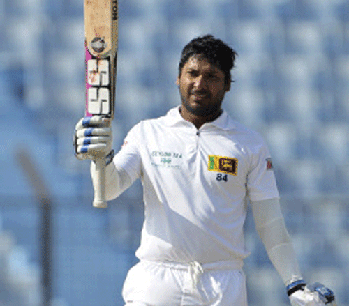 Sri Lanka's Kumar Sangakkara acknowledges the crowd after scoring a century on the first day of the second test cricket match against Bangladesh in Chittagong, Bangladesh, Tuesday, Feb. 4, 2014. Sangakkara's 34th century steered Sri Lanka to a commanding 314-5 against Bangladesh at stumps Tuesday.(AP Photo)
