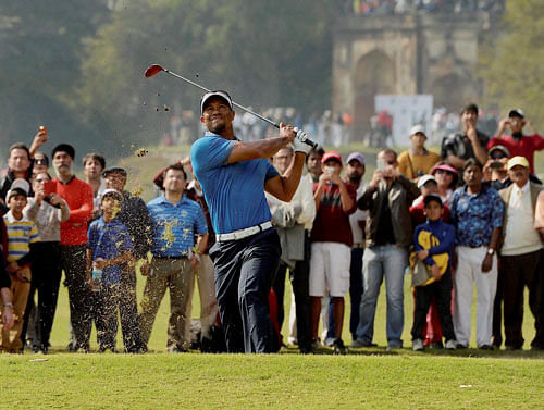 Legendary golfer Tiger Woods tees off during an exhibition match at the Delhi Golf Club on Tuesday. PTI Photo