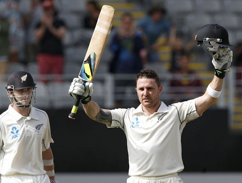 New Zealand's Brendon McCullum celebrates his century while watched by Kane Williamson on day one of the first international test cricket match against India at Eden Park in Auckland February 6, 2014. REUTERS