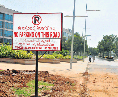 Harsh move: The board erected in the premises of Manyata Tech Park. DH PHOTO BY BK JANARDHAN