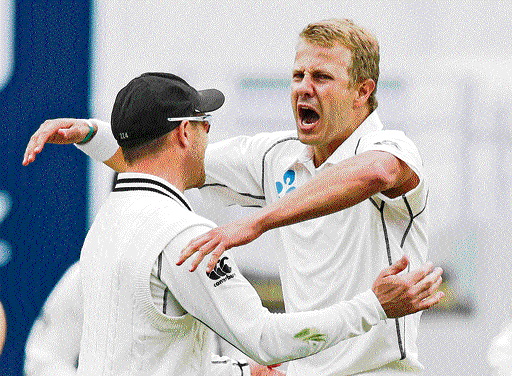 out he goes!: New Zealand's Neil Wagner (right) celebrates the dismissal of India's Murali Vijay on Friday. reuters