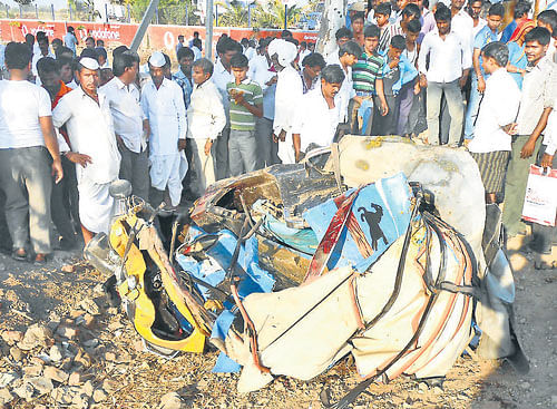 crushed: The mangled remains of the autorickshaw after it collided head-on with a bus on Humnabad-Bijapur National Highway in Jewargi taluk of Gulbarga district on Friday. dh Photo