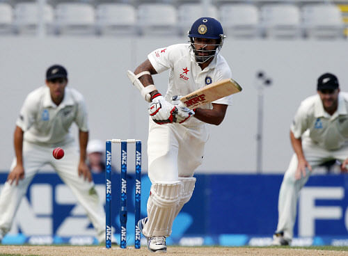 Shikhar Dhawan runs as he plays a shot during his second innings on day three of the first international test cricket match against New Zealand at Eden Park in Auckland, February 8, 2014. REUTERS