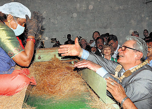 German President Joachim Gauck interacts with a worker of a coir production unit at Tyagatur village in Tumkur district on Saturday. KPN