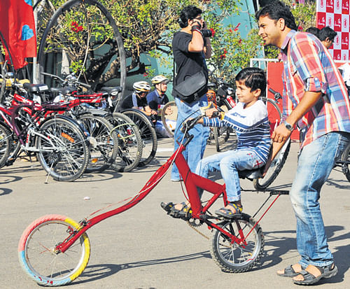 A boy shows off his special cycle at the Cycling Marathon in Bangalore on Sunday. DH Photo