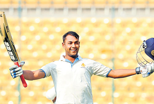Man of the moment: Karnataka's Stuart Binny celebrates his hundred against Rest of India on the second day of the Irani Cup at the M&#8200;Chinnaswamy stadium on Monday. dh photo / srikanta sharma r