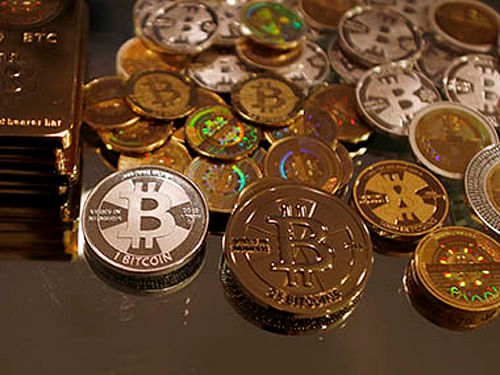 The price of the digital currency bitcoin slid to its lowest level in nearly two months on Monday after bitcoin digital marketplace Mt. Gox said a halt on withdrawals it announced on Friday would continue indefinitely after it detected ''unusual activity.'' Reuters File Photo
