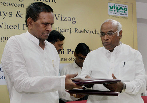 Union Minister for Steel, Beni Prasad Verma exchanging documents with Minister of Railways Mallikarjun Kharge after signing of an MoU between Rashtriya Ispat Nigam Limited (RINL) and Indian Railways for setting up of a Forged Wheel Plant at Raebareli, Uttar Pradesh, in New Delhi on Thursday. PTI Photo by Subhav Shukla