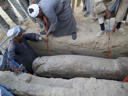 A wooden sarcophagus is lifted from the ground in Luxor, southern Egypt February 10, 2014, in this picture released by Egypt's Supreme Council of Antiquities on February 13, 2014. The 3,600 year-old sarcophagus, which dates back to 1600 B.C. during the reign of the Pharaonic 17th Dynasty, was uncovered with a mummy still inside, according to Egypt's Antiquities Minister. REUTERS