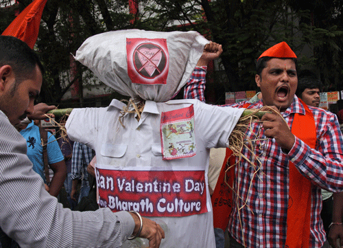 Right-winged Hindu nationalist Bajrang Dal activists shout slogans before burning an effigy symbolizing the Valentine's Day during a protest in Hyderabad, Friday, Feb. 14, 2014. AP