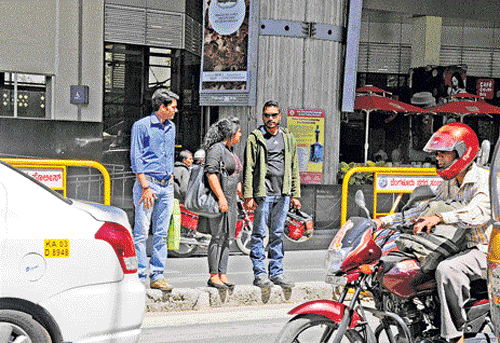 problematic: Commuters struggling to cross to the other side in front of the MG Road Metro Station.  DH PHOTOS BY SK DINESH