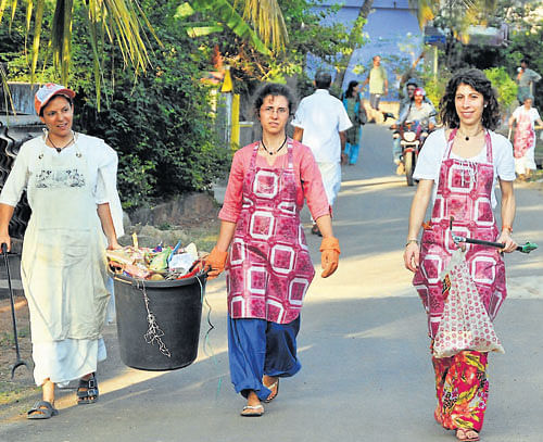 Foreigners clean the Bolur area on the eve of Amma's visit to Mangalore. DH Photo