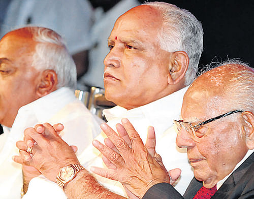 MLA Ramesh Kumar, former chief minister B S Yeddyurappa and senior lawyer Ram Jethmalani at a book release event in the City on Friday. DH Photo