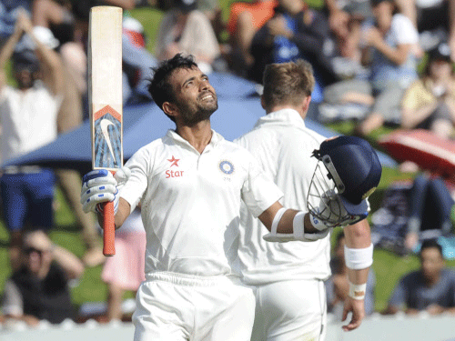 Ajinkya Rahane celebrates his first test century against New Zealand on the second day of the second cricket test in Wellington, New Zealand, Saturday, Feb. 15, 2014. (AP Photo)